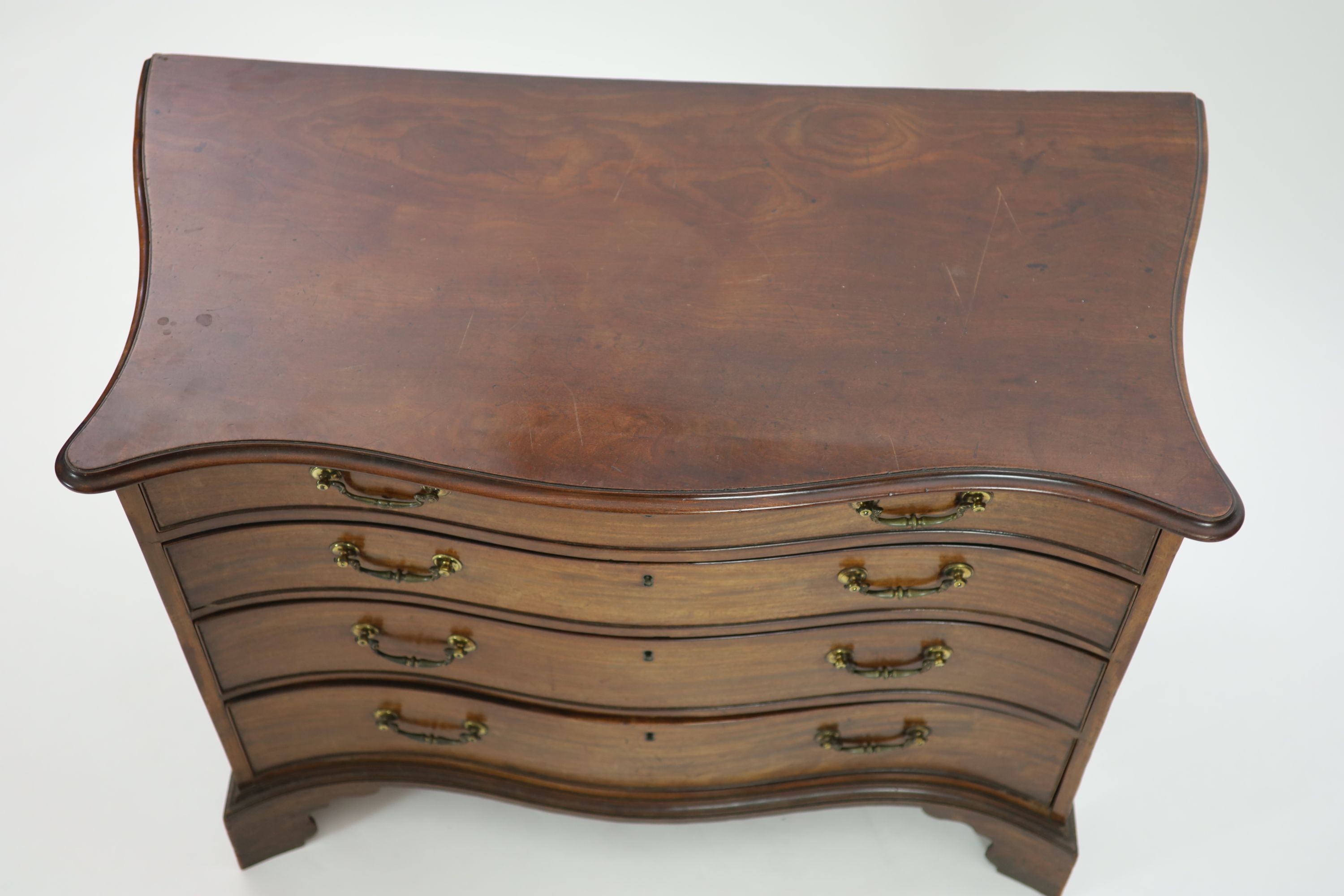 A George III serpentine mahogany chest, W.111cm D.55cm H.81cm